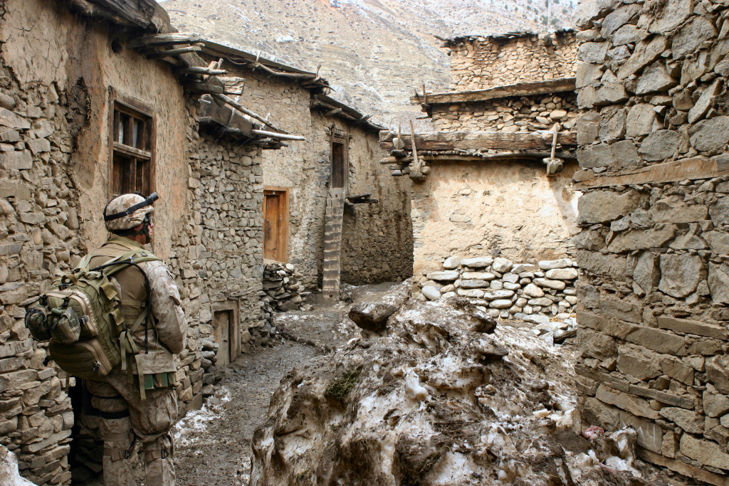 Petty Officer 2nd Class Alonzo Gonzales, a Hospital Corpman with Kilo Company, 3rd Battalion, 3rd Marine Regiment, walks through an alley looking for signs of sickness or disease during Operation Mavericks, an operation that Marines conducted to capture suspected Anti Coaltion Forces in the vicinity of Methar Lam, Afghanistan on March 19, 2005. 3rd Battalion, 3rd Marines is conducting security and stabilization operations in support of Operation Enduring Freedom. (U.S. Marine Corps photo by Corporal James L. Yarboro) Released